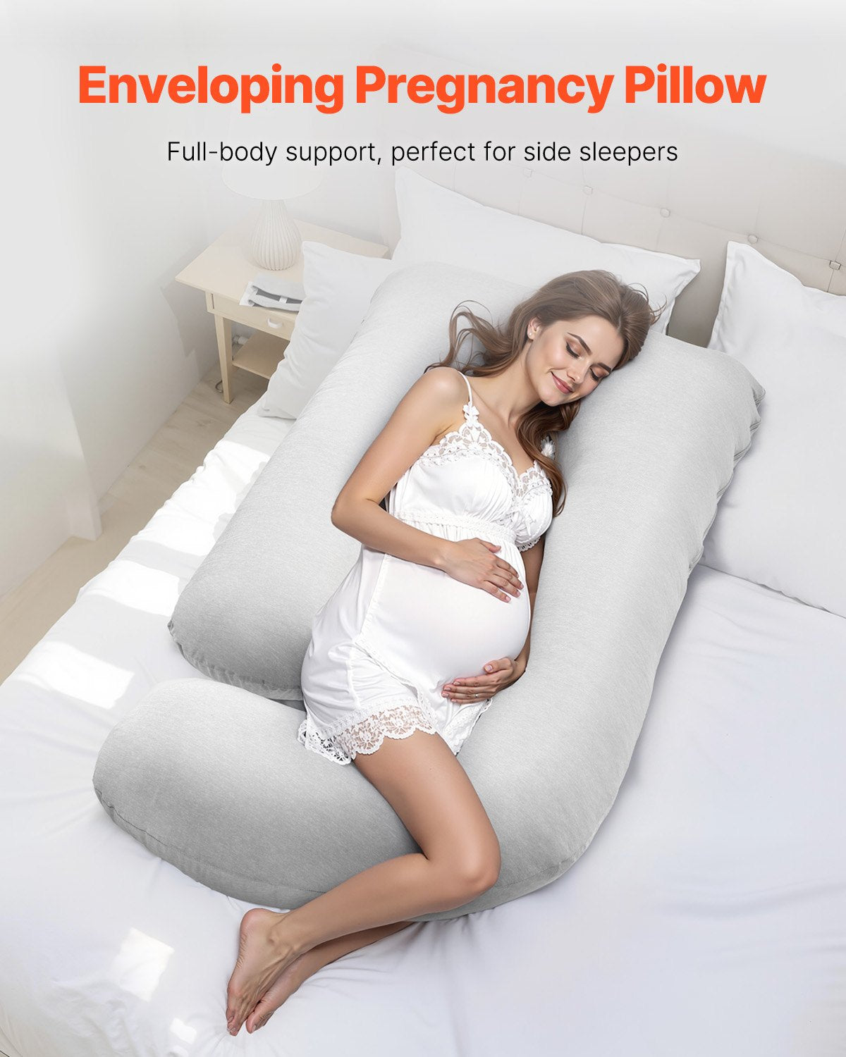 Pregnant woman sleeping on G-shaped maternity pillow